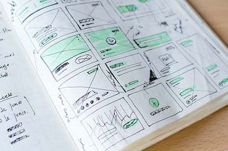 A notebook with sketched wireframes